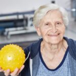 Senior woman with ball in occupational therapy