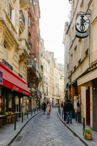 Quaint Paris street lined with historic buildings and shops, capturing a vibrant urban scene.