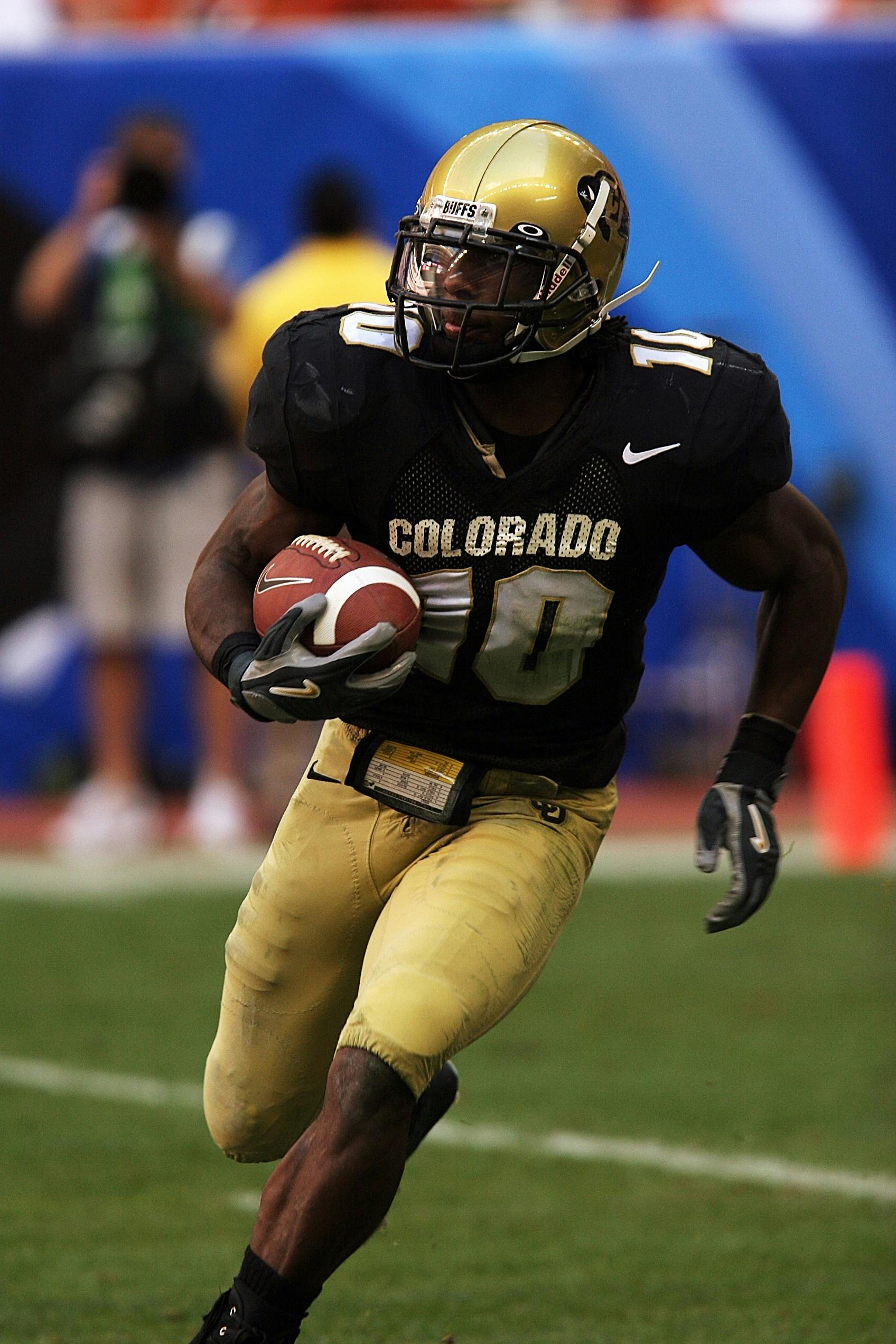 Dynamic action shot of an American football player running on the field during a game.